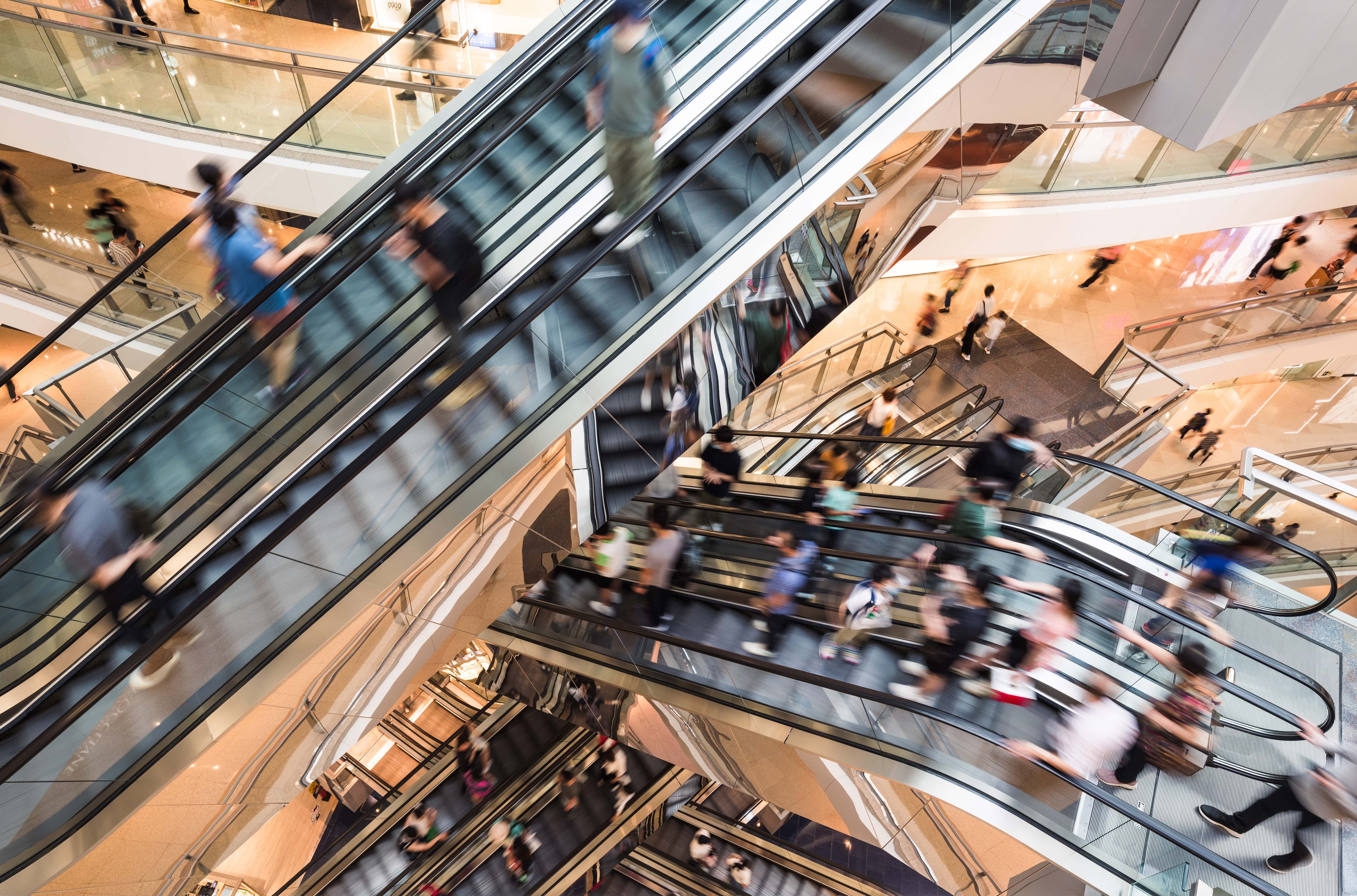 Blurry photo of people on escalators
