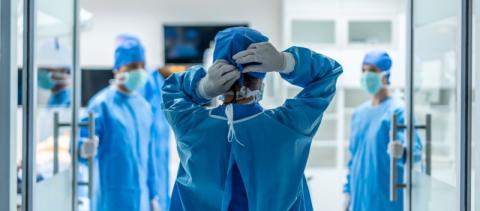 Surgeon open door to operating theatre Healthcare communication Solutions